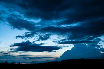 Sunset behind the village with big clouds