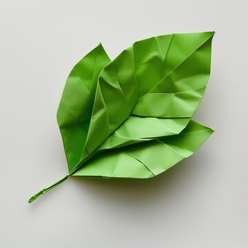A green leaf made of origami paper, on a white background, with a simple, flat design, photographed at high resolution in the style of origami , high quality