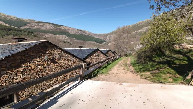 Stone houses next to the mountain with slate roofs on the route of black villages, Spain.