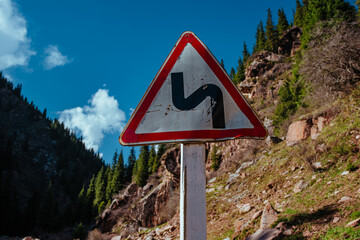 Dangerous turn sign on mountain road