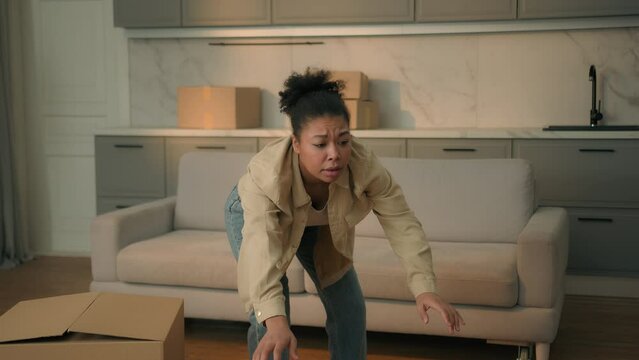 African american woman renter home owner moving in new house relocation day female courier carry deliver cardboard boxes to apartment tired girl drop parcels upset displeased failure shopping delivery