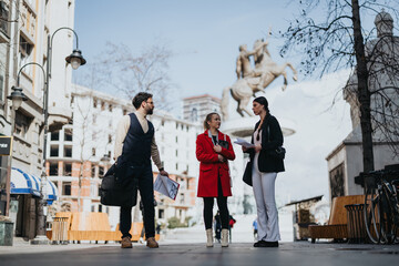 Energetic young entrepreneurs engage in a strategic outdoor meeting in a city environment, discussing trends and markets.