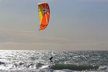 Kitesurfer riding his board toeside