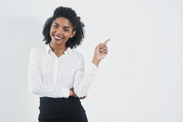 Pointing, happy and portrait of business black woman on a white background for promotion in studio....