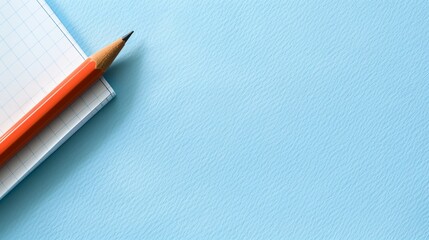 a pencil resting on a piece of paper on a blue surface