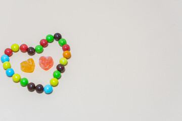 Heart shaped Candy and multi colored candy on Isolated on White Background.
