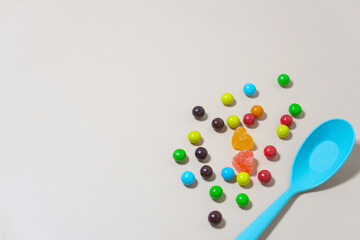 Heart shaped Candy and multi colored marble candy with spoon on Isolated on White Background.