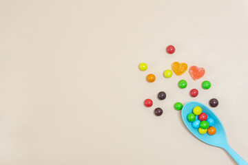 Heart shaped Candy and multi colored marble candy with spoon on Isolated on White Background.