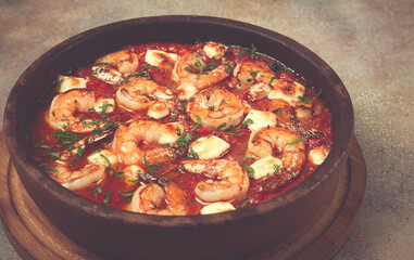 saganaki with shrimp, in a clay pan, Greek dish, shrimp in tomato sauce, feta cheese, homemade, no people,