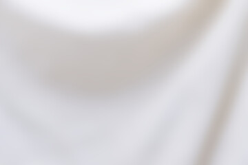 Abstract white background with a smooth curve. Blurred bright background from white fabric...