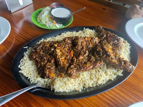 rice with chicken. chicken with rice and vegetables. Arabic food kuzhi mandhi 