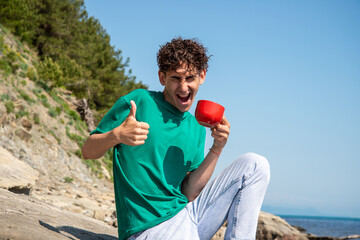 A young attractive guy is resting by the sea.