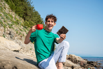 A young attractive guy is resting by the sea.