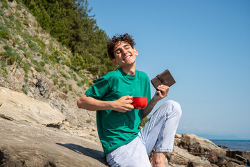 A young attractive guy is resting by the sea.