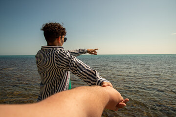 Love and romance. Two guys are walking along the beach.