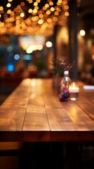 b'An empty wooden table in a restaurant with a candle and a vase on it'