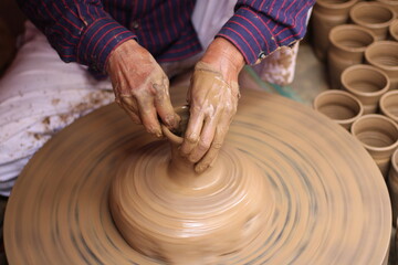 A skilled potter crafting a bowl in a pottery workshop or studio