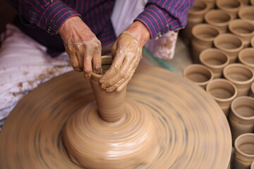 A skilled potter crafting a bowl in a pottery workshop or studio
