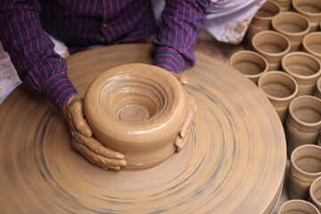 A skilled potter crafting a bowl in a pottery workshop or studio