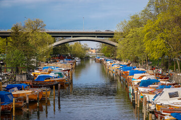 Small boats docked at a canal in city