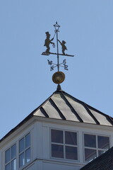 weather vane man and child lighting old time candle light