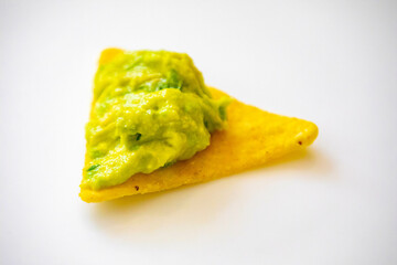 Traditional corn tortilla with avocado guacamole. Isolated on white background