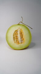 A piece of greeniegal melon isolated on a white background