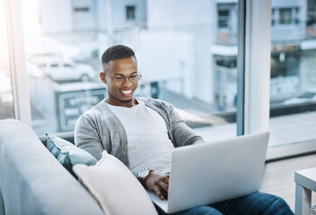 Black man, couch and home with laptop for relax, watching movies and streaming app. African male...