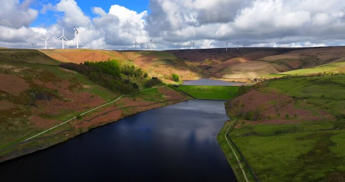 Aerial image of Naden valley middle reservoir and wind turbines at the top of the hills in Rochdale, Greater Manchester