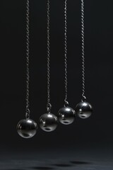 A group of metal balls hanging from chains. Ideal for industrial concepts