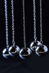 A group of pendulums hanging from a chain. Perfect for physics and science concepts