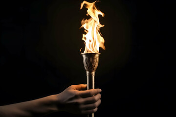 Closeup, Hand holding Olympic Games fire torch isolated on black background