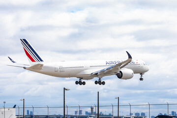 Obraz premium Mississauga Canada, April 9, 2022; An Air France Airbus A350 clearing the fence at the end of the runway for landing at at Toronto Pearson Airport YYZ