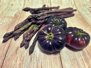 black tomatoes, tomatoes with black skin, fresh vegetables, bowl of tomatoes, purple asparagus, fresh dark asparagus, purple colored vegetables