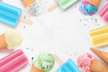 Variety of colorful pastel ice cream cones and popsicle summer frozen desserts. Top down view frame...