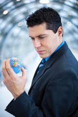 Businessman holding globe in his hand