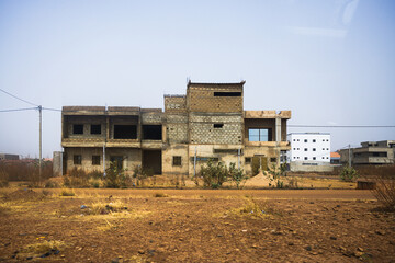 an abandoned building on a dirt road, ouagadougou, burkina faso