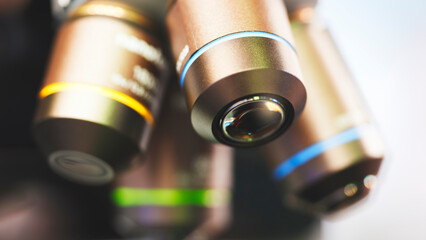 Close-up shot of microscope with lens at laboratory.