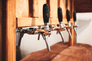 Beer bar counter with a row of taps for dispensing beer, wooden furniture, rustic style