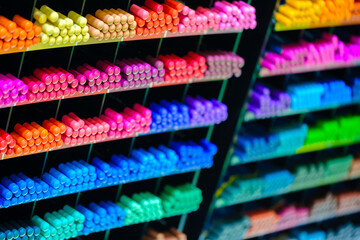 A colorful display of pens and pencils with the numbers 1 through 7 on the side. The pens are arranged in rows and are of various colors