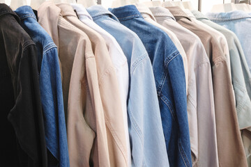 A rack of clothes with a variety of colors and patterns