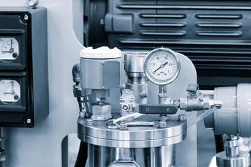 A close up of a pressure gauge on a machine, industrial concept background