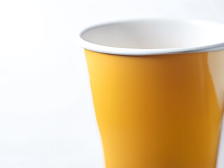 Close-Up of a Yellow Paper Cup on a White Background