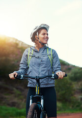 Obraz premium Thinking, woman and mountain bike in outdoors, fitness and cycling sports for adventure on trail. Person, athlete and bicycle for exercise in nature, workout and training for off road competition
