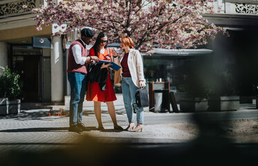 Three business professionals engaging in a strategy session outdoors, with documents on a sunny day.