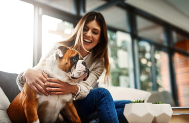 Woman, dog and hug on sofa in home for happy connection with best friend relaxing, bonding or...