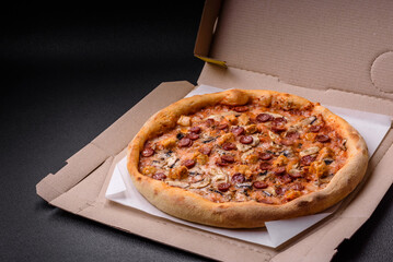 Delicious pizza with sausage, cheese, tomatoes, salt, spices and herbs