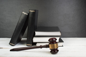 Law concept - Open law book with a wooden judges gavel on table in a courtroom or law enforcement office isolated on white table. Copy space for text. - 798134117