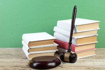 Law concept - Open law book with a wooden judges gavel on table in a courtroom or law enforcement office isolated on white background. Copy space for text. - 798134525