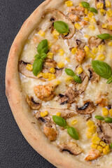 Delicious pizza with corn, cheese, tomatoes and mushrooms, salt, spices and herbs